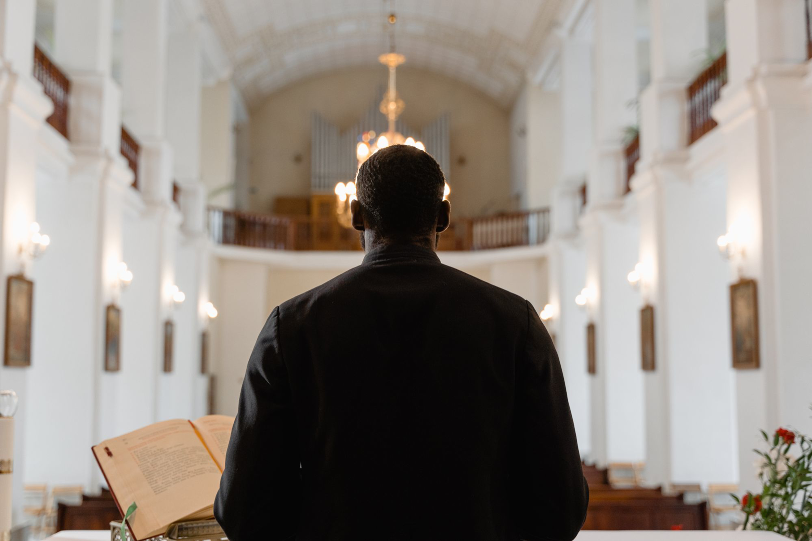 A pastor at the pulpit, seen from the congregation