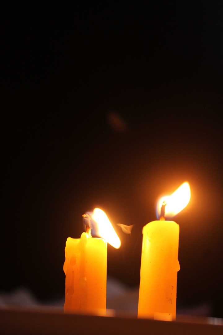 Candle flames in a dark sanctuary