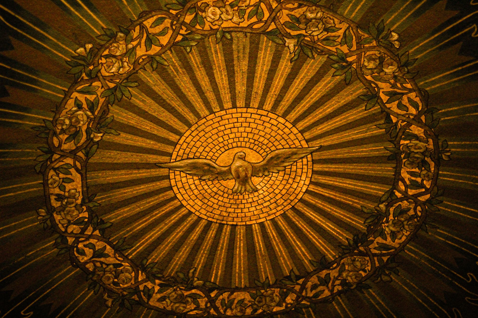 A baptismal font filled with water, lit in gold