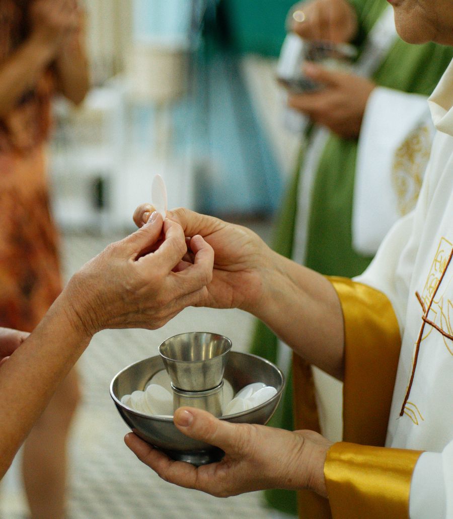 Hands sharing communion bread