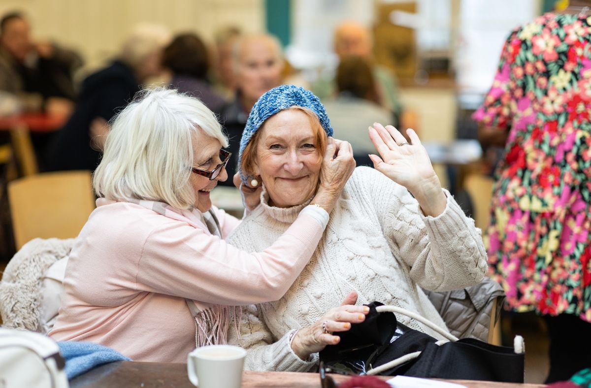 Women laughing together over coffee
