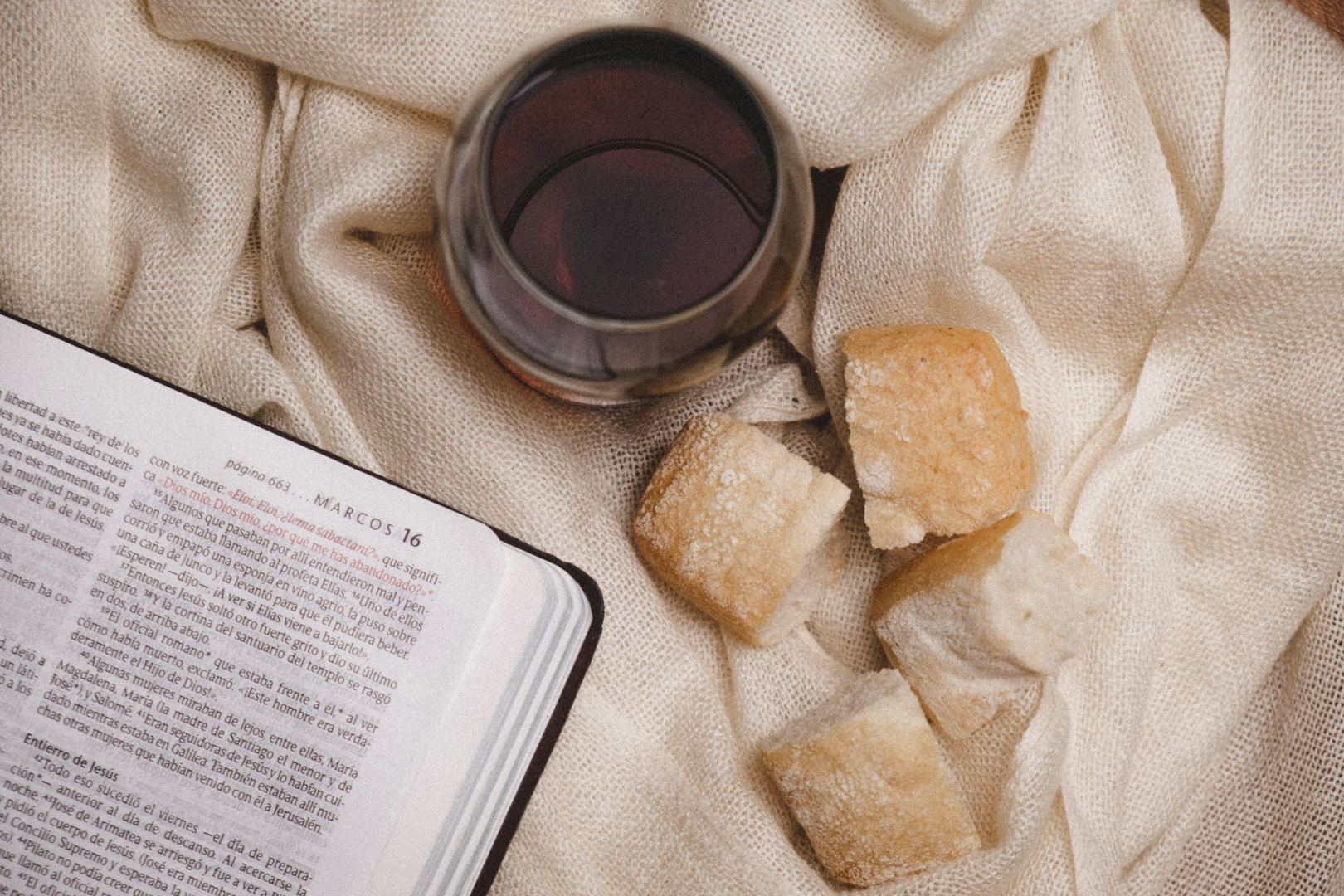 An open Bible resting on soft fabric