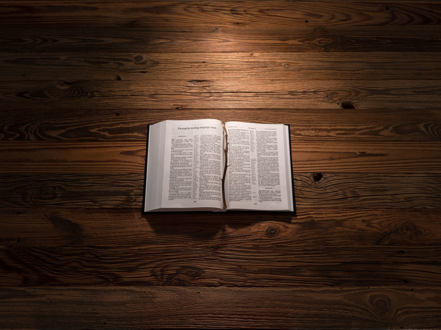 An open Bible on a wooden table
