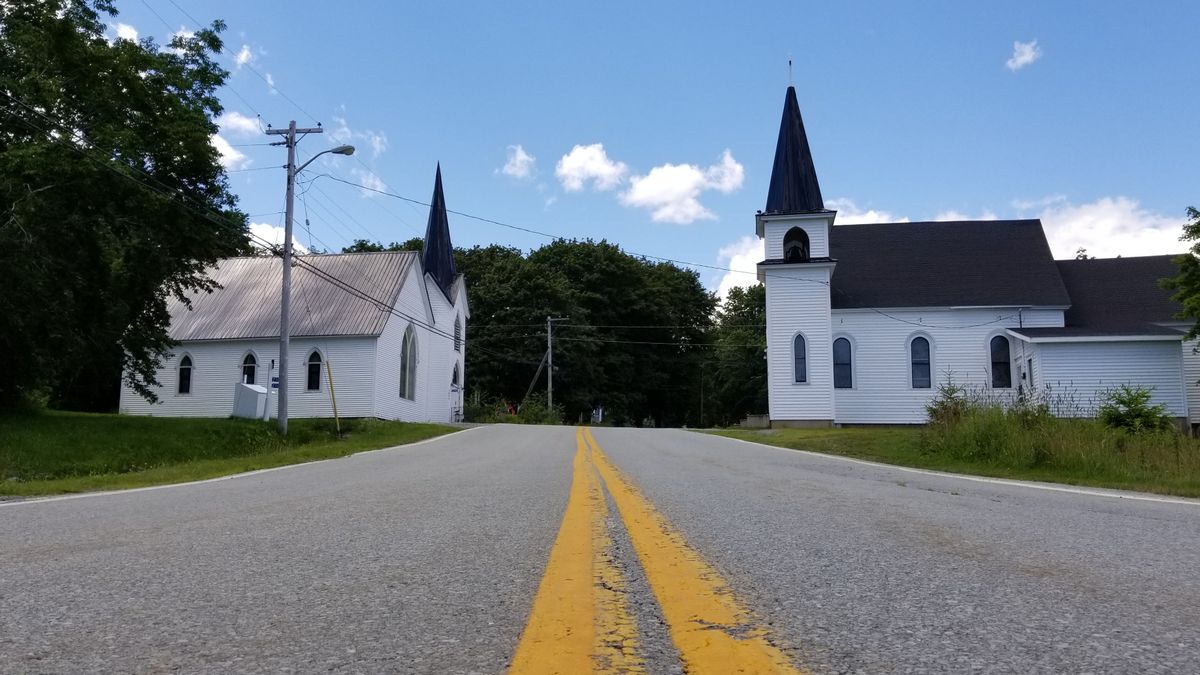 A small white church along a country road