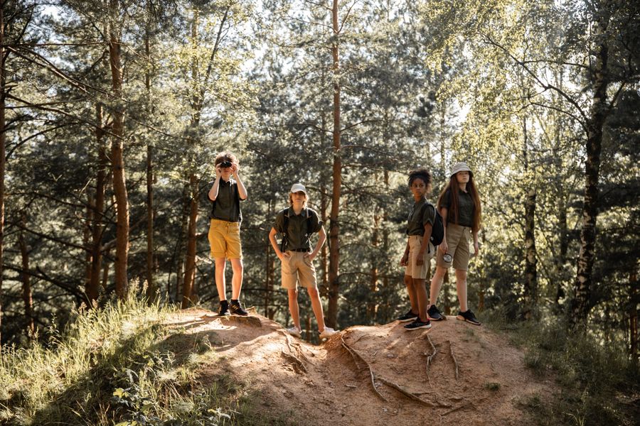 A group of young people hiking through a forest