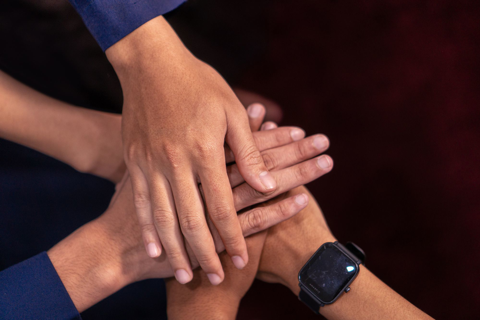 Hands stacked together in a circle